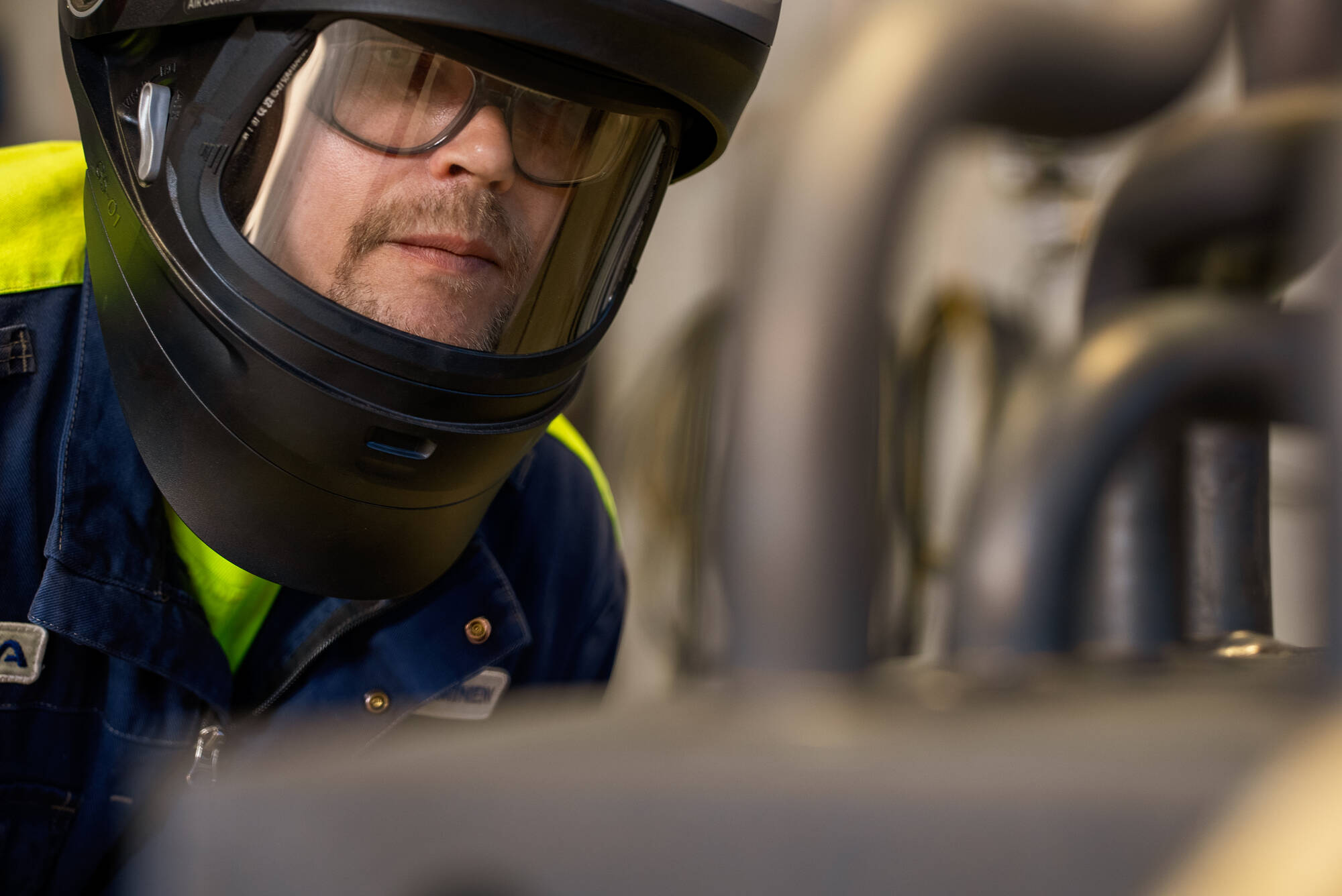 Production worker in close-up looking at a welded product