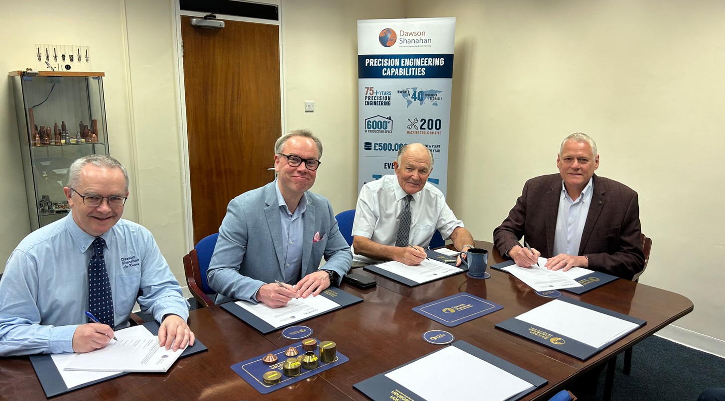 People sitting around a table signing a contract
