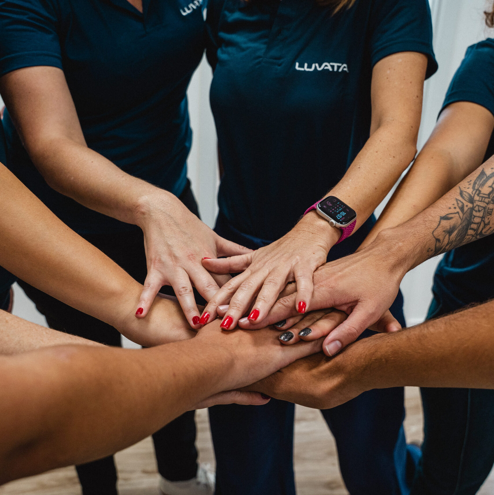 Team putting hands together in the middle